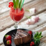 chocolate cake with strawberries and a red drink